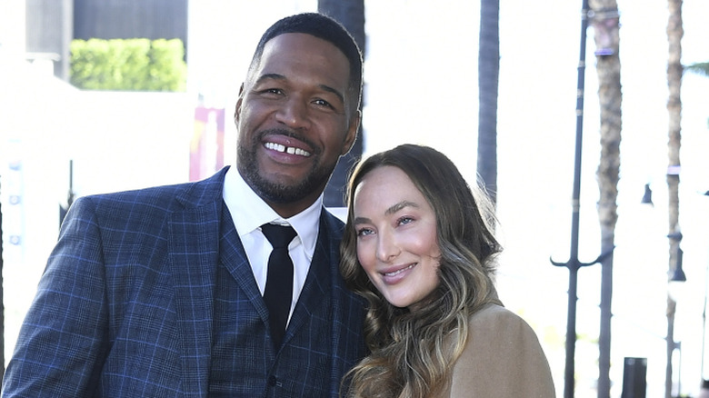 Michael Strahan and Kayla Quick smiling at event