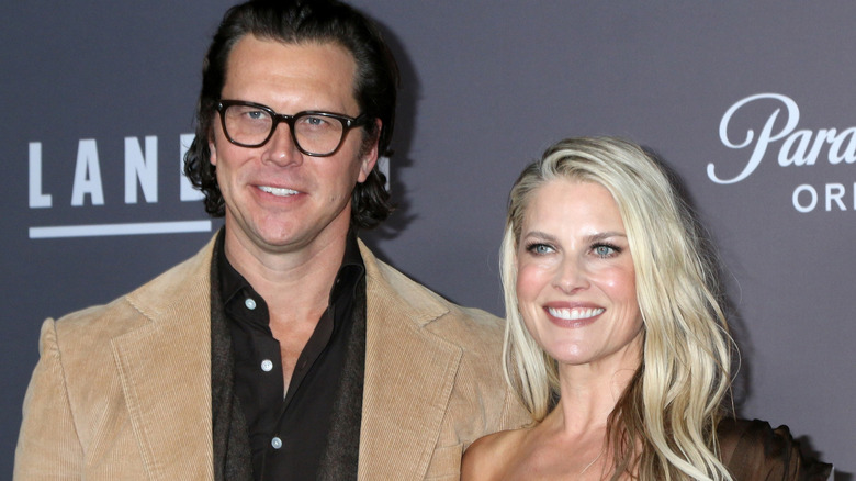 Ali Larter smiling with her husband Hayes MacArthur at a press event