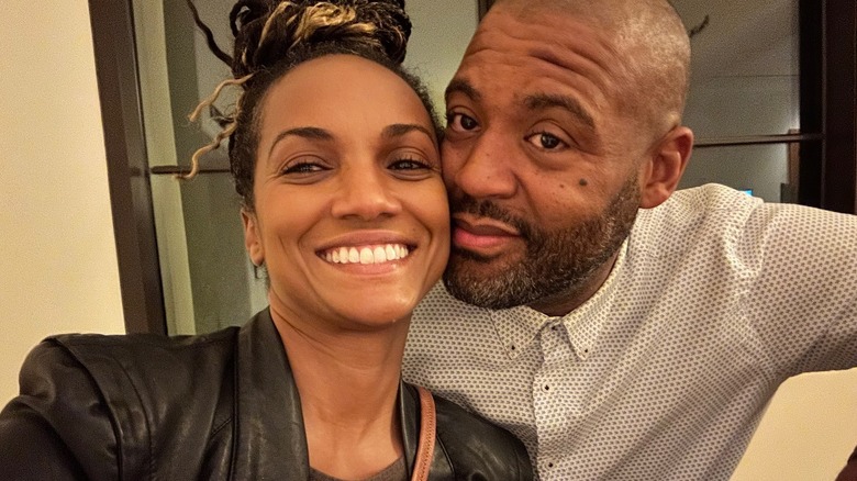 Mekia Cox and her husband snuggling up together