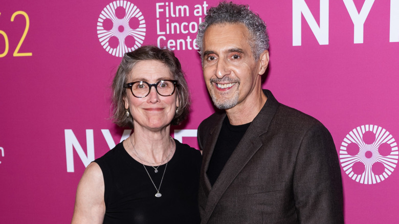 John Turturro and Katherine Borowitz against a pink background