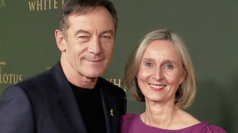 Jason Isaacs and Emma Hewitt smiling at the White Lotus premiere