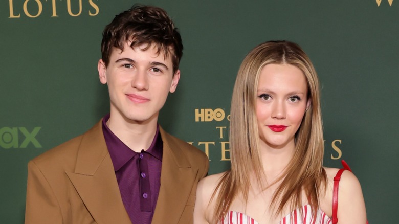 Sam Nivola and Iris Apatow smiling at the White Lotus premiere