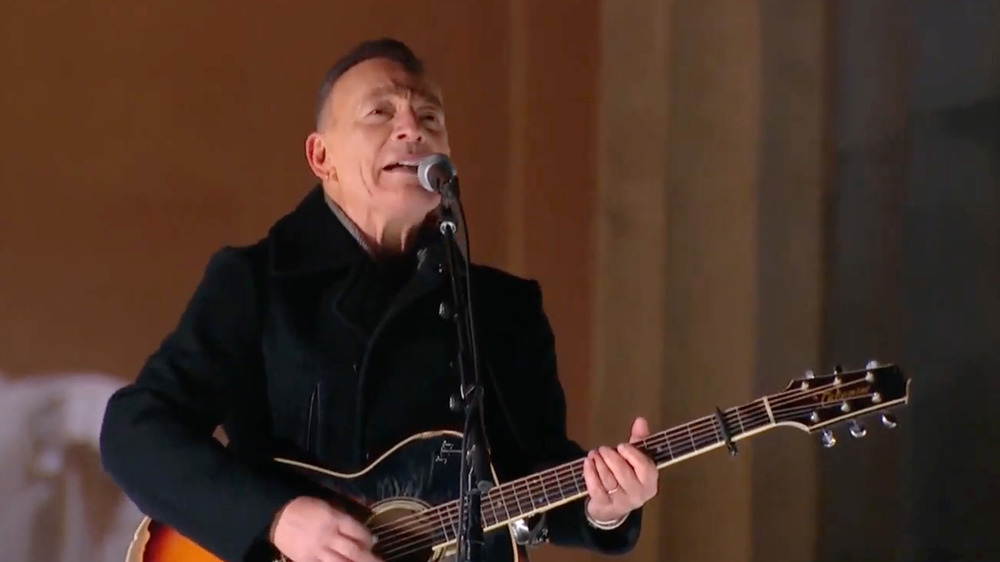 Bruce Springsteen at inauguration concert holding guitar and singing