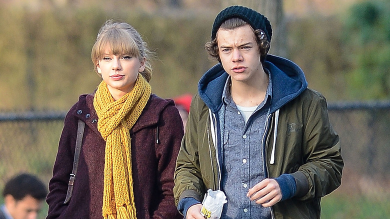 Taylor Swift and Harry Styles walking in park