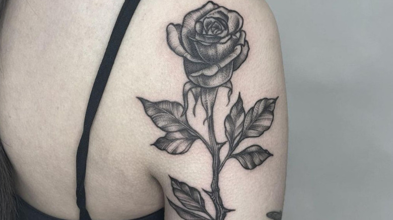 Black rose tatted on arm