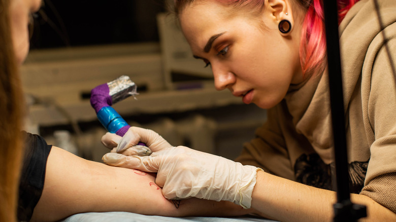 Woman getting a tattoo