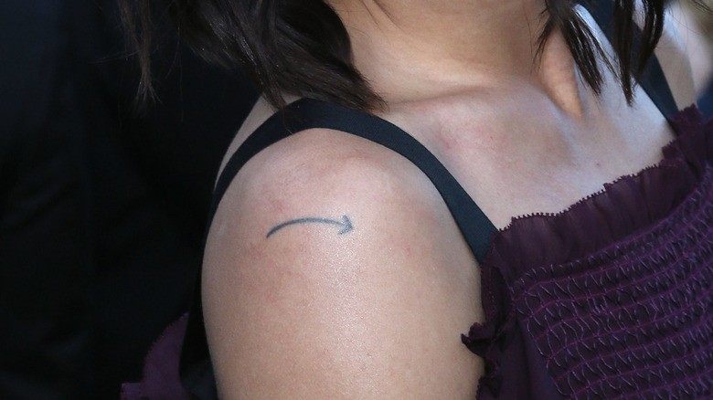 Jessica Szohr curved arrow tattoo on shoulder 