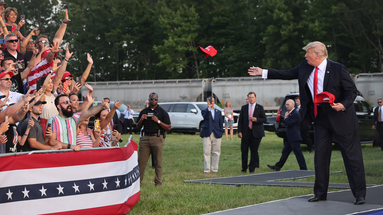 Donald Trump tossing hats at the crowd