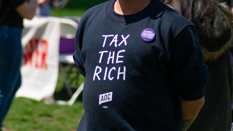 man wearing tax the rich shirt 