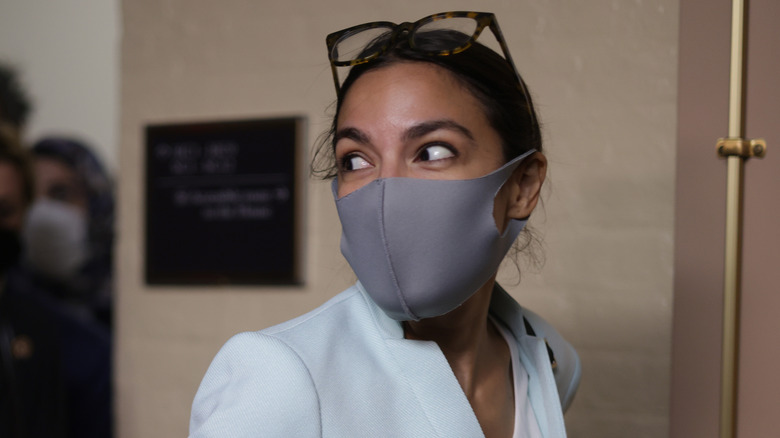 AOC wearing face mask and looking to the side