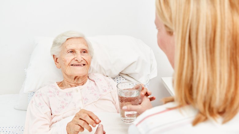 elderly woman cared by young woman