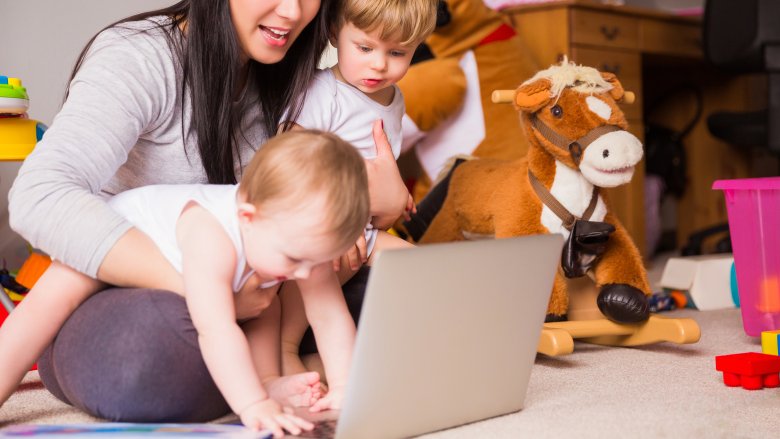 mom trying to multitask with two kids