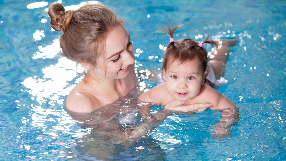 Mother and baby in pool