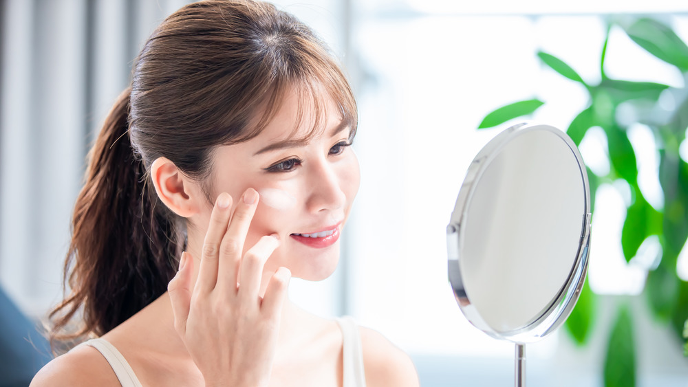 Woman applying sunscreen