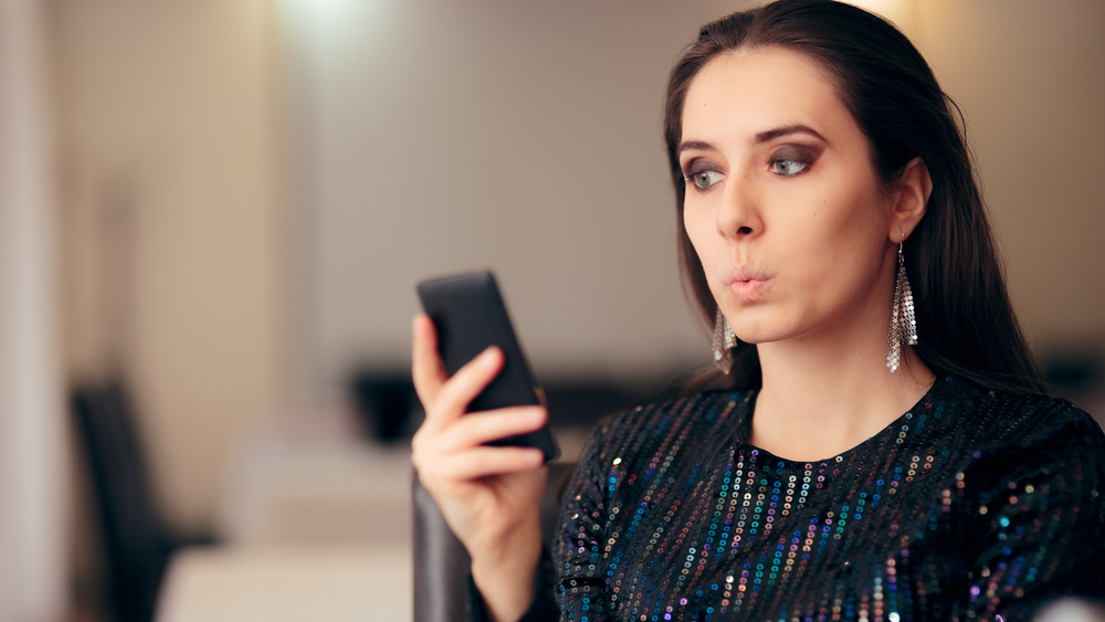 Woman reacting to phone screen