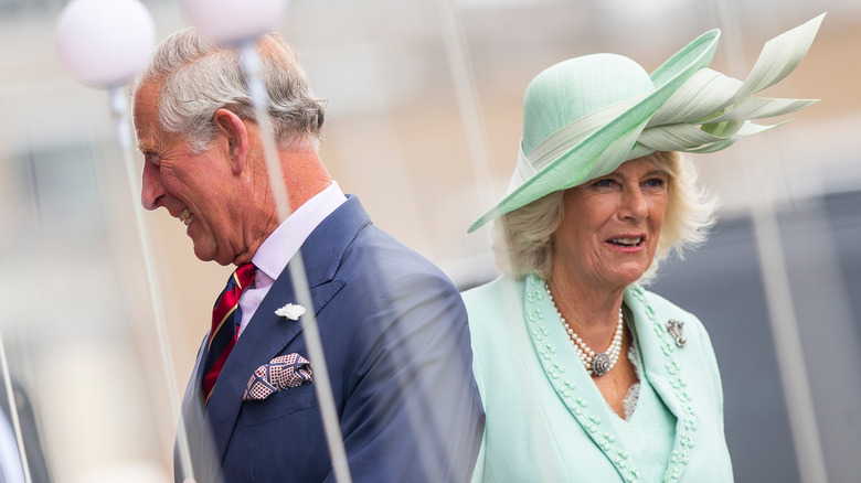 Camilla Parker Bowles and Prince Charles laughing back to back