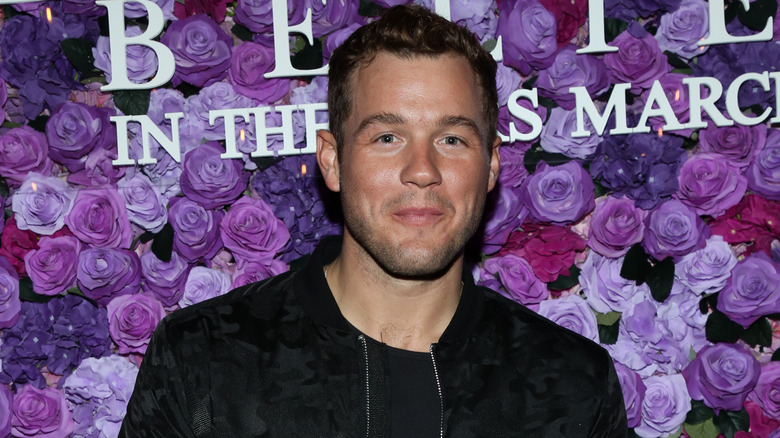 Colton Underwood grinning in black