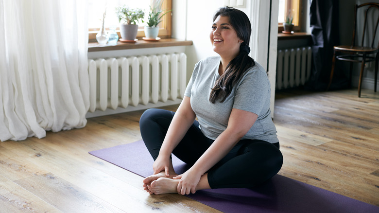 Woman doing yoga in apartment