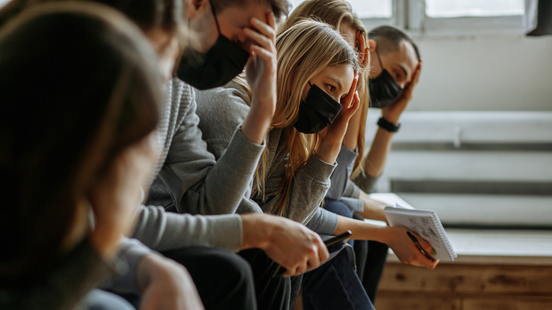 People wearing masks waiting room