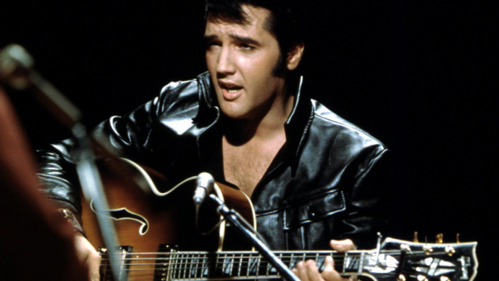 Elvis plays guitar