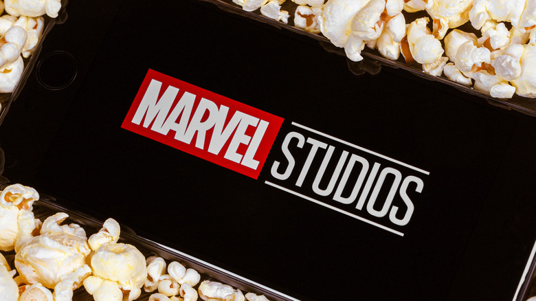 Marvel Studios logo on phone surrounded by popcorn