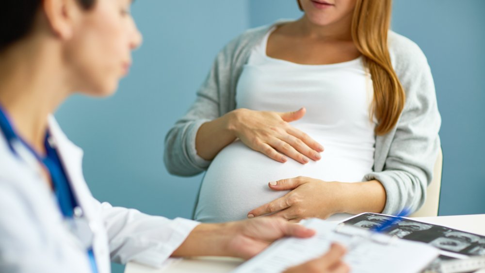 Doctor checking pregnant woman