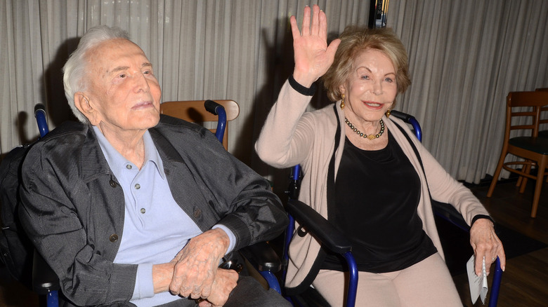 Kirk Douglas sitting with wife