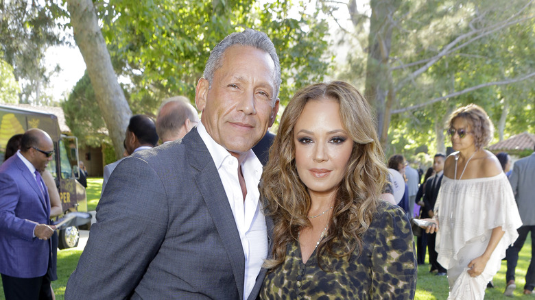 Angelo Pagan and Leah Remini outdoors