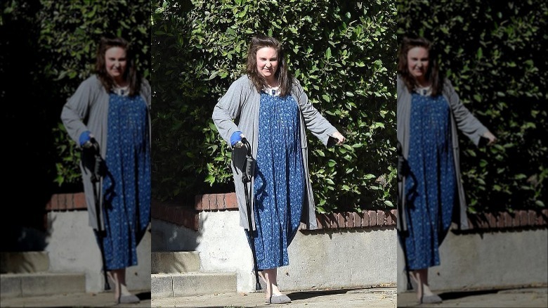 Lena Dunham with a cane