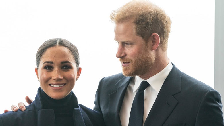 Prince Harry with arm around Meghan Markle