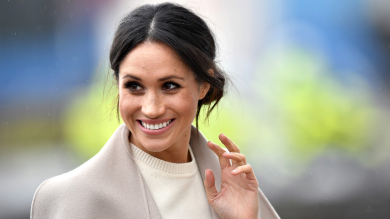 Meghan Markle smiling and waving