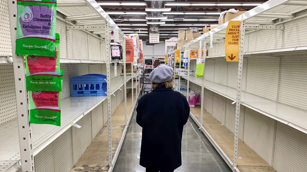 Shopper checking out empty shelves