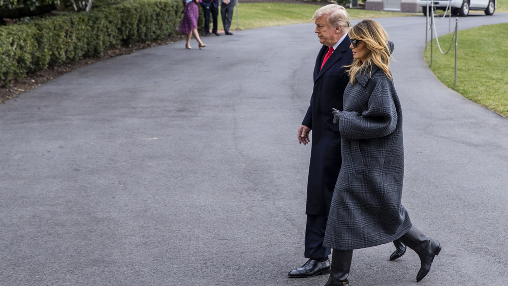 Donald Trump and Melania Trump outdoors in coats