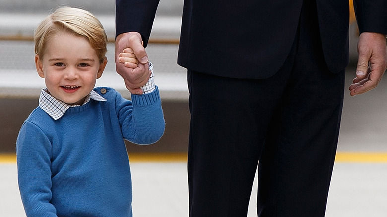 Prince George waring shorts and a sweater.