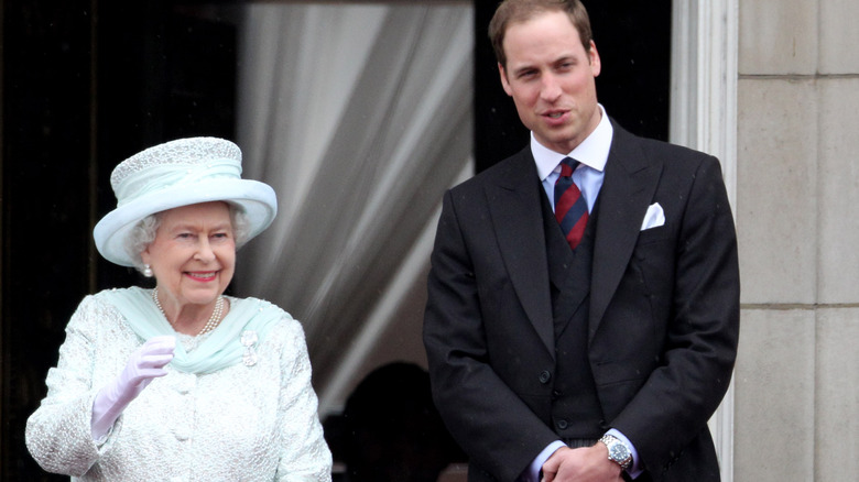 Queen Elizabeth II and Prince William standing