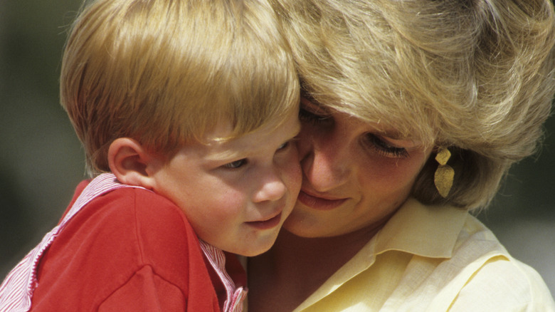 Princess Diana holds baby Prince Harry close 