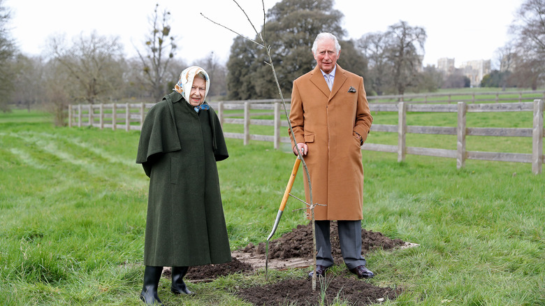 Queen Elizabeth and Prince Charles planting a tree 