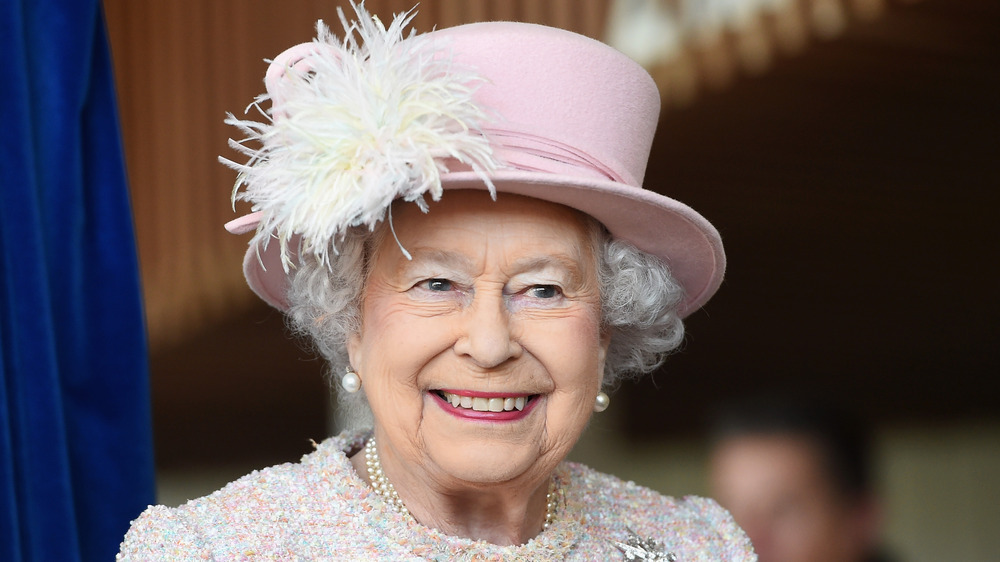 Queen Elizabeth smiling in pink