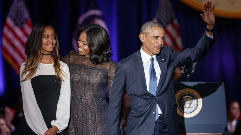 Barack Obama waving with Malia and Michelle Obama