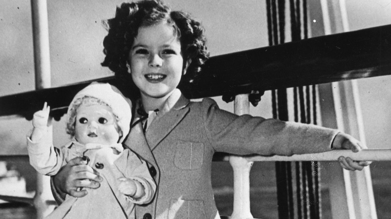 Shirley Temple holding a doll