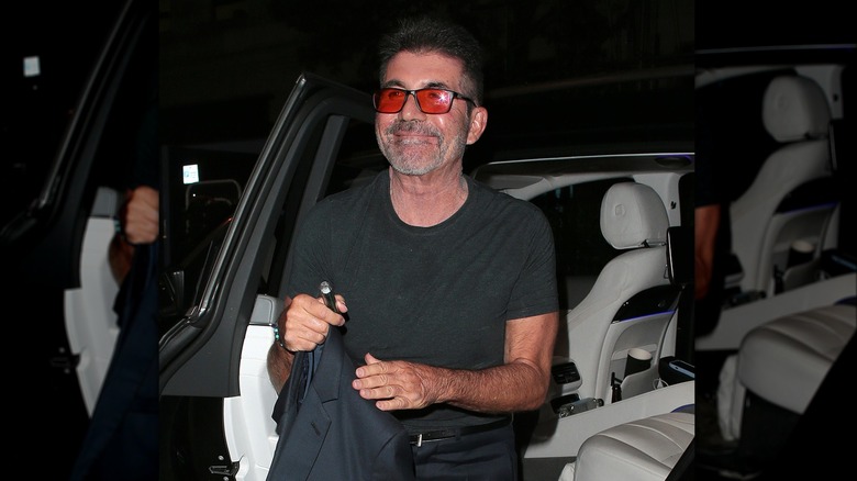 Simon Cowell pictured by a car