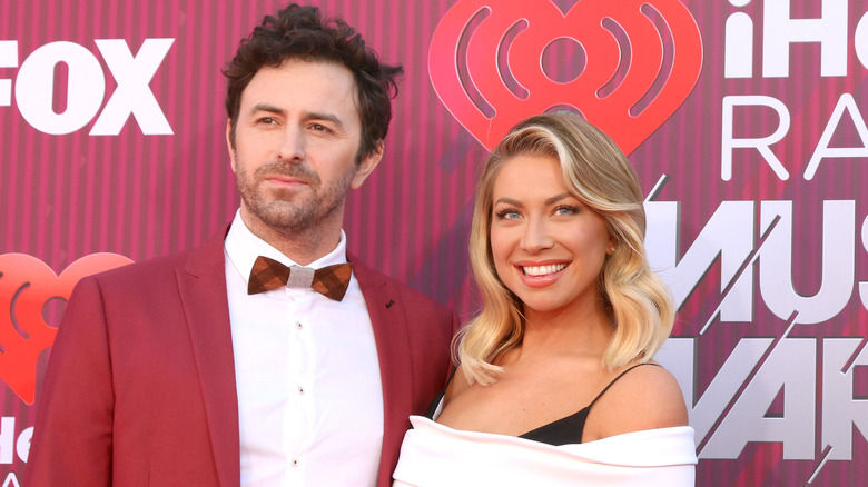 Beau Clark and Stassi Schroeder posing at iHeart Radio event 