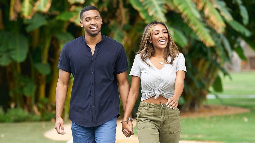 Tayshia Adams and Ivan Hall holding hands