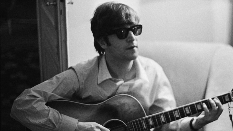 John Lennon playing a guitar