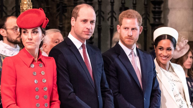 Kate Middleton, Prince William, Prince Harry, and Meghan Markle standing