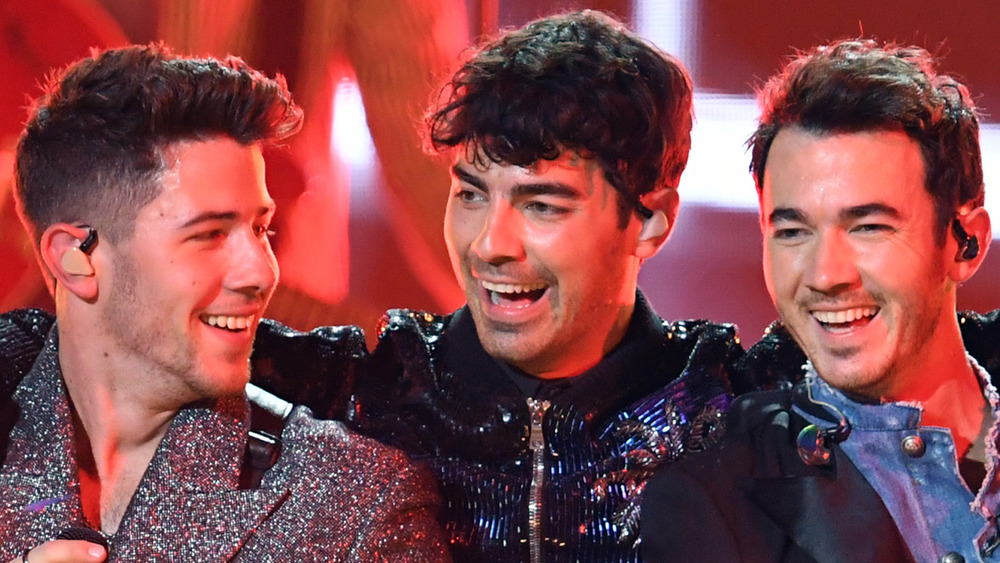 The Jonas Brothers celebrate onstage together