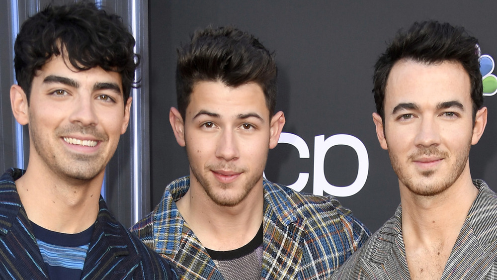 The Jonas Brothers pose on the red carpet together