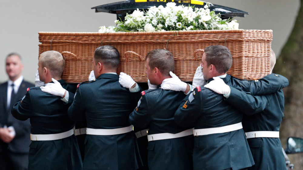 A group of soldiers carrying a coffin