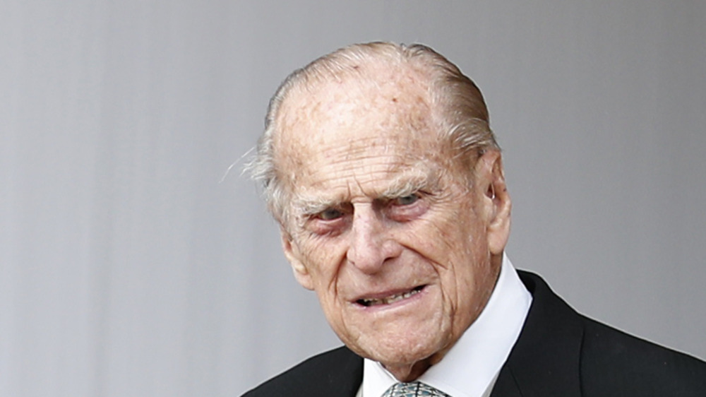 Prince Philip smiling in black suit jacket