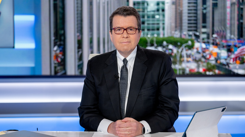 Neil Cavuto gently smiles, wearing a black tux